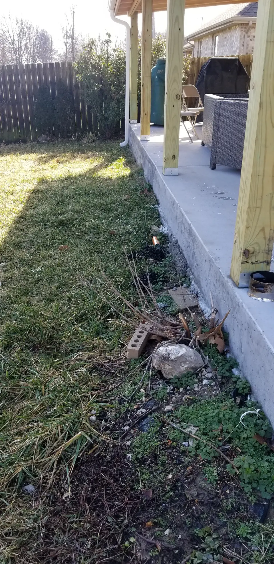 Retaining wall with paver steps and red mulch beside a patio, recent work by L&M Lawncare