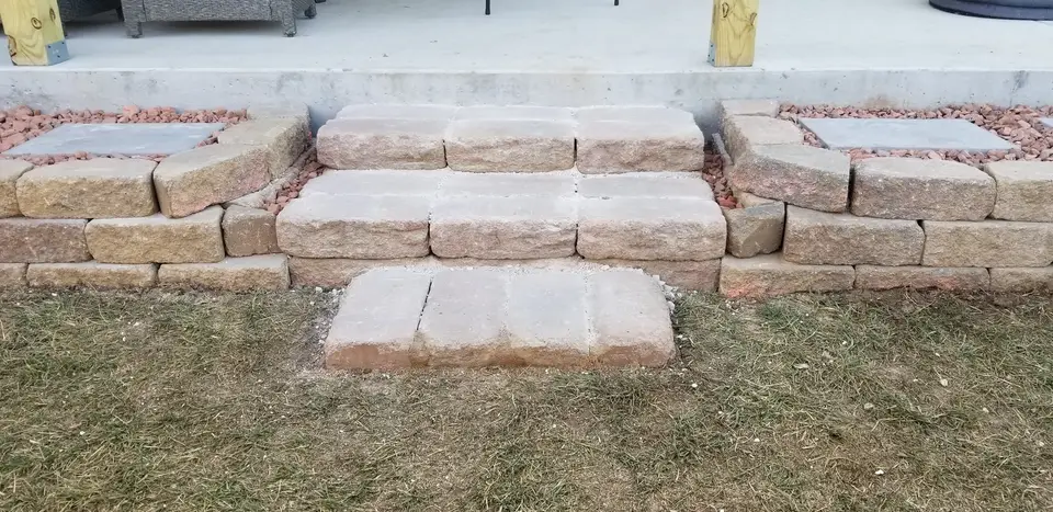 Block steps and pavers built in front of a patio by L&M Lawncare